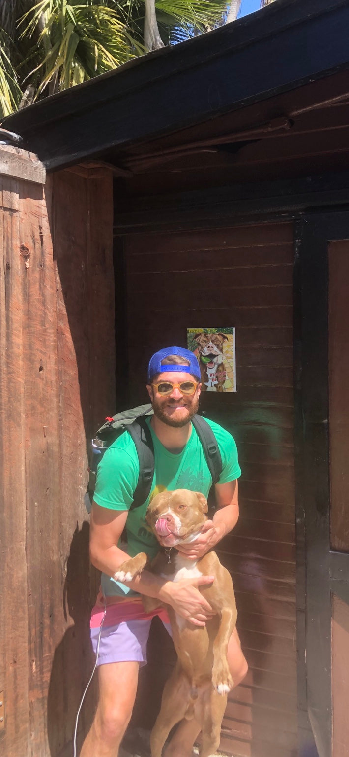 Spencer with Zeke at the Junglow Bungalow in Manhattan Beach, with the Beware of Dog painting in the background